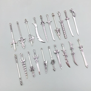 Macro view of assorted silver alloy fantasy weapon charms for DIY jewelry and keychains