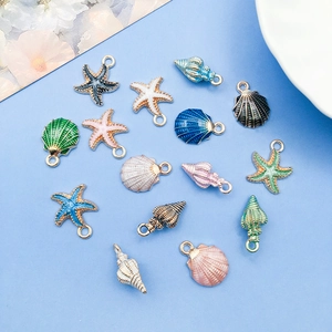 Close-up of colorful enamel starfish and seashell pendants for DIY jewelry making