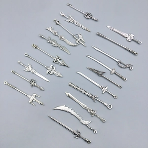 Detailed close-up of 16 antique silver alloy miniature sword and weapon charms for DIY