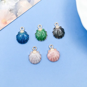 Macro detail of shell-shaped enamel charms in five colors with alloy bases for DIY crafts