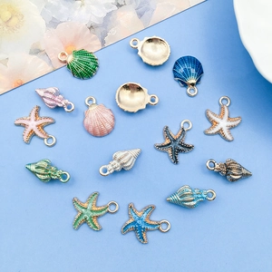 Detailed close-up of colorful ocean shell and starfish alloy pendants for jewelry making