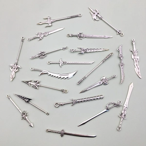 Detailed close-up of various vintage silver alloy weapon charms for DIY jewelry making