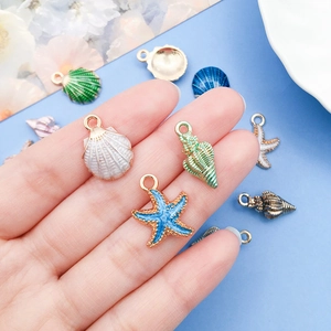 Macro detail of alloy sea shell and starfish charms for DIY jewelry making