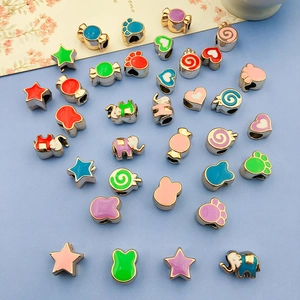 Macro detail of various colorful enamel animal and star beads for DIY jewelry making