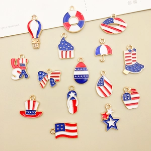 Detailed flat lay of 15 Independence Day alloy pendants with red white and blue enamel
