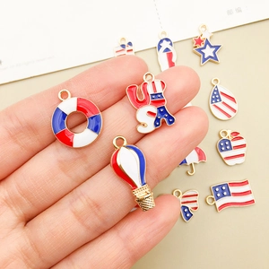 Handheld set of USA flag themed enamel alloy charms in red white and blue colors