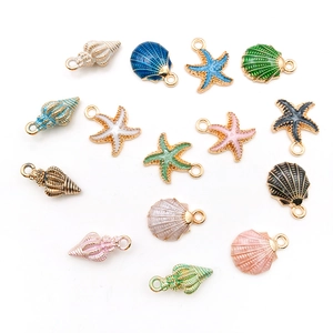 Macro shot of colorful enamel starfish and seashell metal charms for DIY jewelry making