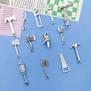 Macro detail of various silver DIY alloy tool pendants with vintage metallic textures