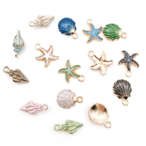 Macro view of ocean-themed starfish and seashell alloy charms with colorful enamel finish