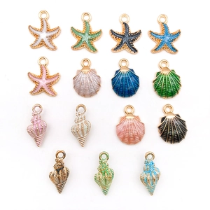 Macro detail of alloy enamel sea charms including starfish shells and conchs for DIY jewelry