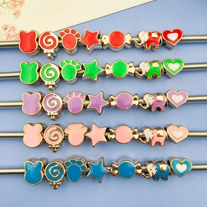 Close-up of colorful enamel charms like rabbits and elephants for DIY jewelry making