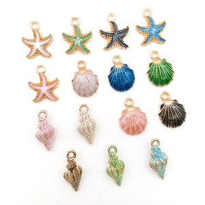 Macro view of colorful enamel alloy starfish and seashell charms for DIY jewelry making