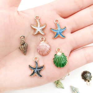 Colorful sea shell starfish alloy charm set held in hand for DIY jewelry making