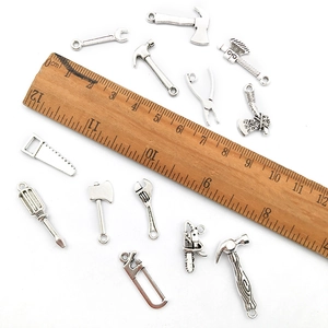 Set of vintage silver alloy tool pendants including wrench and hammer for DIY jewelry