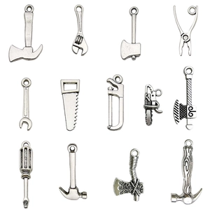 Set of vintage silver alloy tool pendants including mini axe, wrench, and saw for DIY jewelry