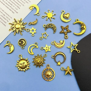 Detailed view of vintage gold alloy charms featuring sun, moon, and star celestial motifs
