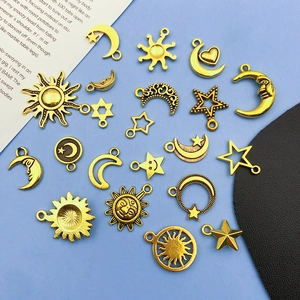 Detailed close-up of golden celestial sun and moon charms for DIY jewelry making crafts