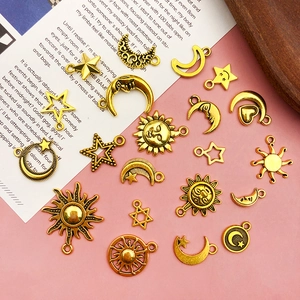 Detailed view of vintage gold alloy sun moon and star pendants for DIY jewelry making