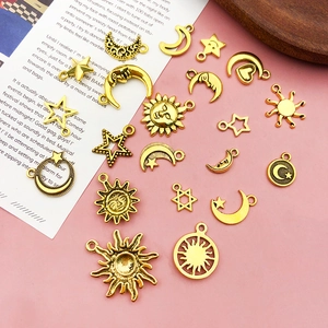 Flat lay of vintage gold celestial charms featuring sun, moon, and star for DIY jewelry