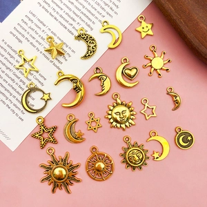 Macro detail of retro gold alloy sun and moon pendants for creative DIY jewelry making