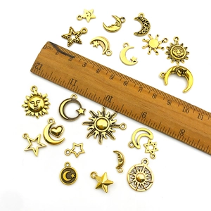 Golden alloy celestial charms with sun, moon and star designs for DIY jewelry making