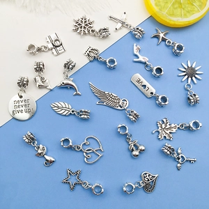Close-up of assorted antique silver alloy charms for DIY bracelets and necklaces