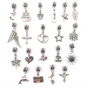 Set of 20 vintage silver alloy pendants including heart, leaf, and animal shapes for DIY jewelry