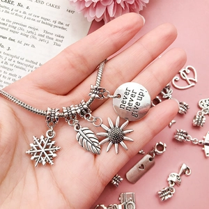 Retro DIY silver-toned charm bracelet featuring floral pendants and inspirational engraving