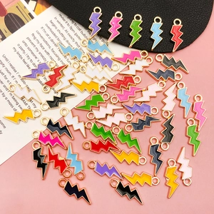 Flat lay of colorful enamel lightning bolt charms in gold finish for DIY jewelry