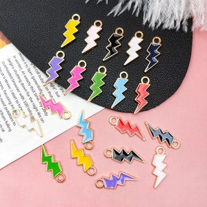 Macro detail of lightning bolt charms with colorful enamel finish and gold metal edges