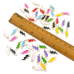 Colorful lightning bolt enamel charms for DIY jewelry making shown with a ruler