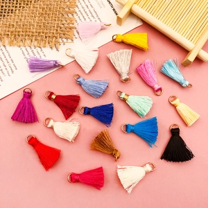 Close-up of colorful mini silk tassels with metal jump rings for DIY jewelry making