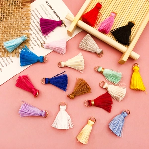 Detailed macro view of colorful mini silk tassels with golden metal hanging rings