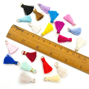 Set of colorful mini thread tassels with metal rings and size measurement guide