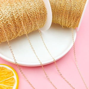 Close-up of 18K gold plated copper cable chain on rolls for DIY jewelry making