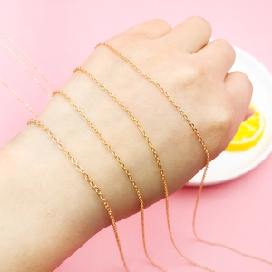 Detail of 18K gold-plated copper snake chain for DIY jewelry making on a pink background