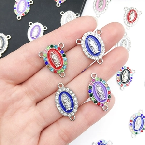 Detail van kleurrijke ovale Maria-bedeltjes met strass-steentjes voor doe-het-zelf sieraden