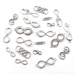 Detailed macro view of silver infinity symbol charms and alloy connectors for DIY jewelry