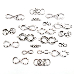 Macro detail of silver infinity symbol charms in various styles for DIY jewelry making