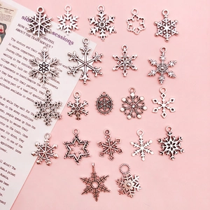 Detailed view of assorted silver snowflake alloy charms for DIY jewelry making