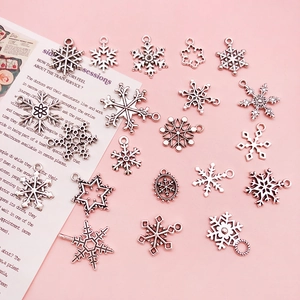 Macro view of assorted silver zinc alloy snowflake charms for DIY jewelry making