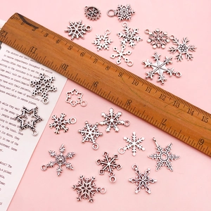 Silver zinc alloy snowflake pendants for DIY jewelry making with ruler for size reference