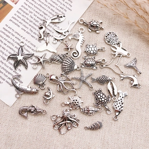 Detailed view of assorted silver alloy ocean charms including turtles and seahorses for DIY