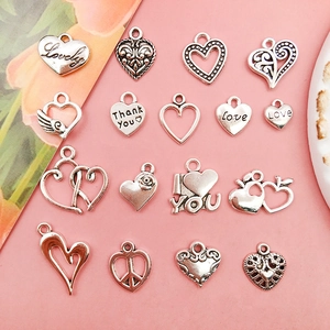 Macro shot of 16 assorted vintage silver heart alloy charms for DIY jewelry making