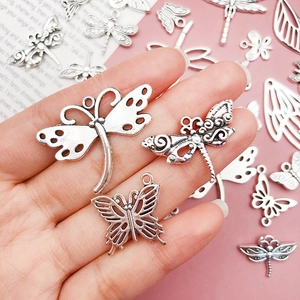 Detailed view of antique silver insect charms for DIY jewelry making in various designs