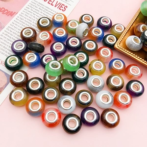 Flat lay detail of gradient cat-eye large hole beads for DIY charm bracelet kits