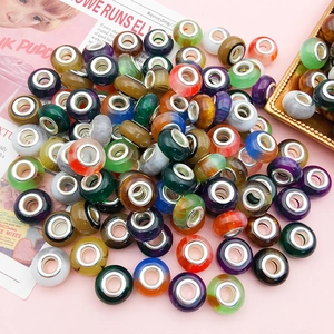 Macro shot of colorful gradient cat-eye beads with metal cores for DIY jewelry crafting