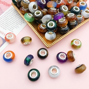 Macro shot of gradient cat eye beads with metal cores for DIY jewelry bracelets