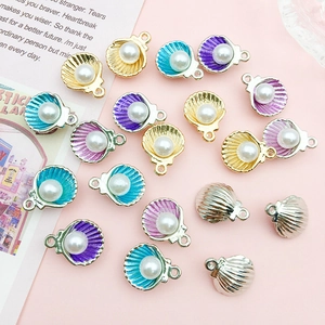 Detail view of colorful alloy shell charms with white pearls for DIY jewelry making