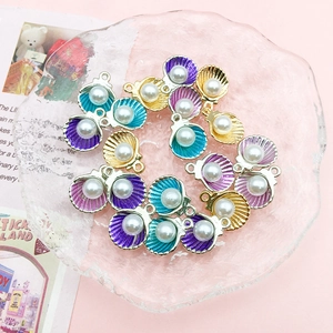 Colorful shell pendants with pearls for DIY jewelry making on a pink background